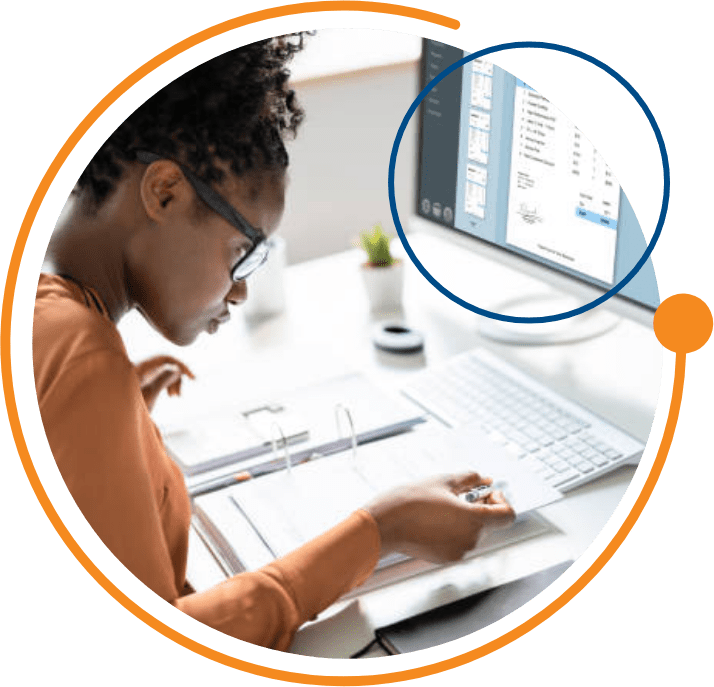 A woman checks over her payroll with VCS software on the computer